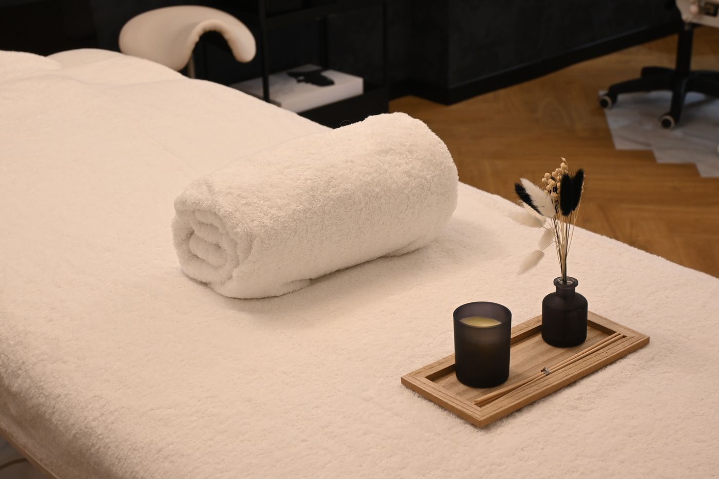Rolled towel, candle, and calm spa décor
