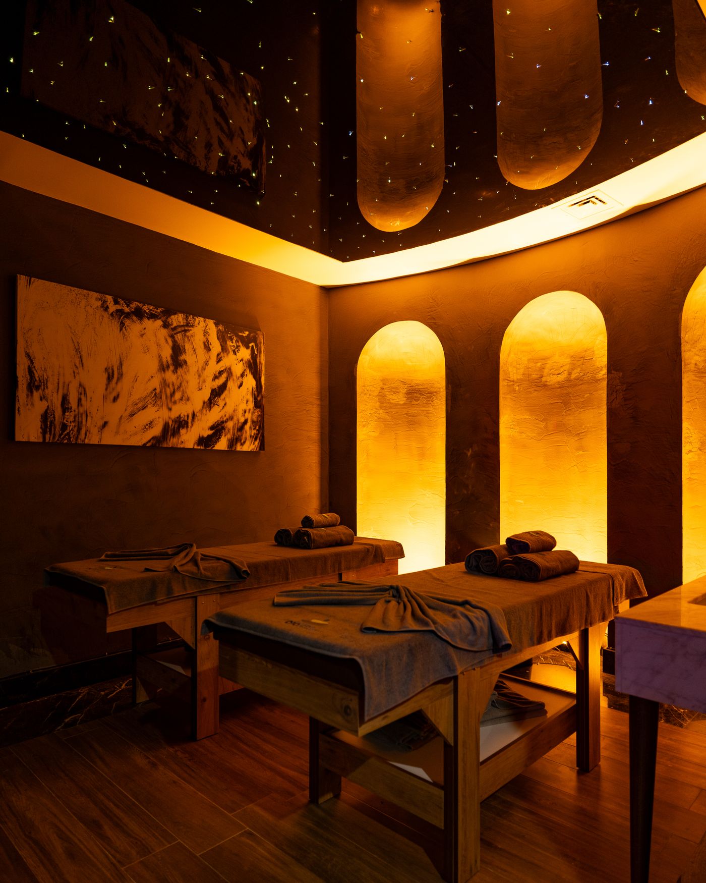 Warm, luxurious spa room prepared for two guests
